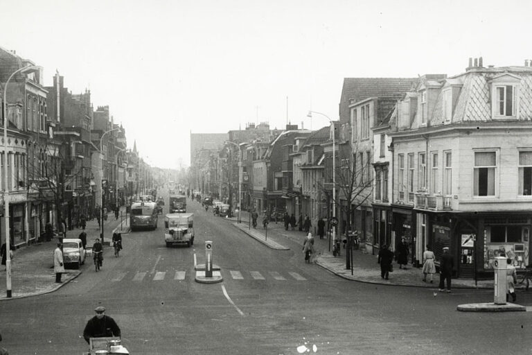 altes Foto einer Straße mit niedrigen Gebäuden auf beiden Seiten