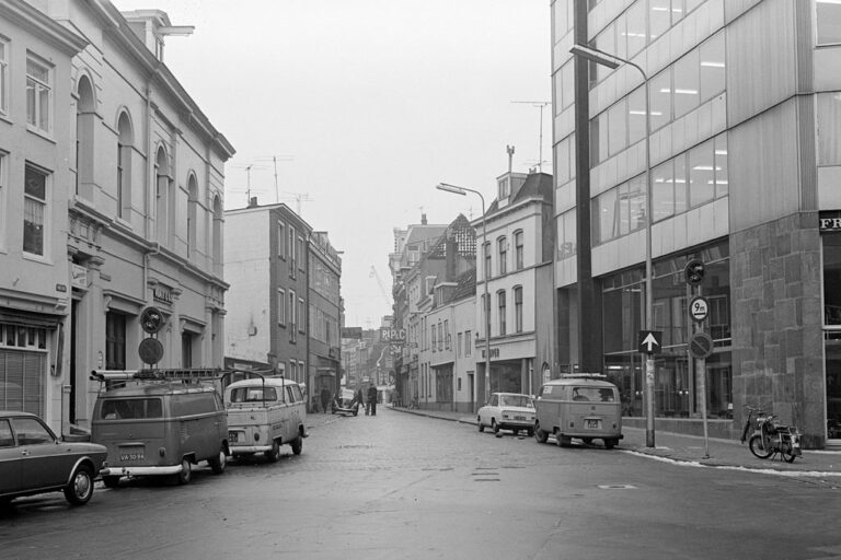 Autos parken links und rechts von einer Straße im Zentrum von Utrecht, altes Foto